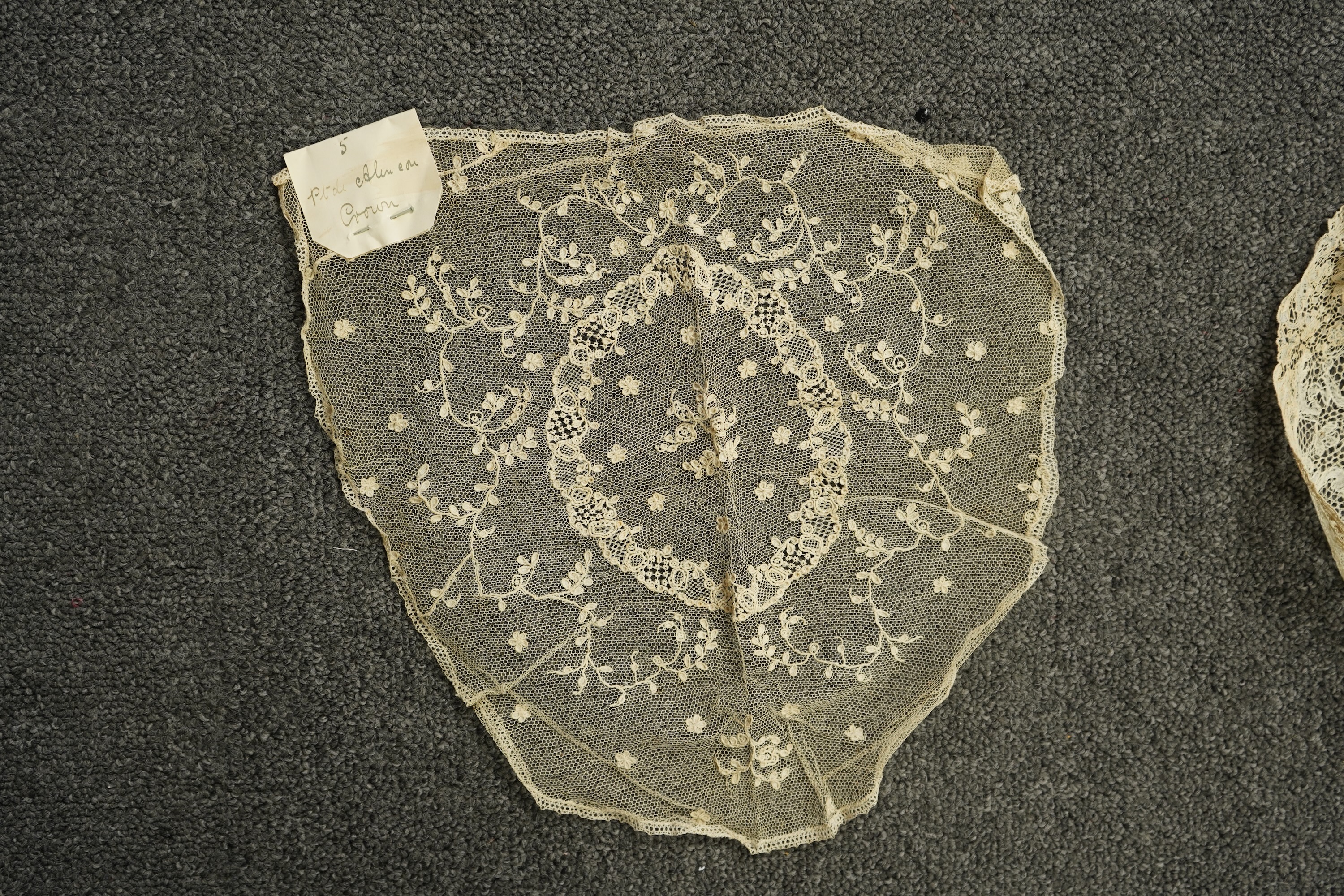 A collection of 18th century needle and bobbin lace. Including an 18th century wide pair of joined Valenciennes lace lappets, a similar 18th century cap back, an ornately worked Point de Alencon cap crown and another sim